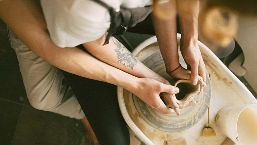 A couple doing pottery together as seen from above