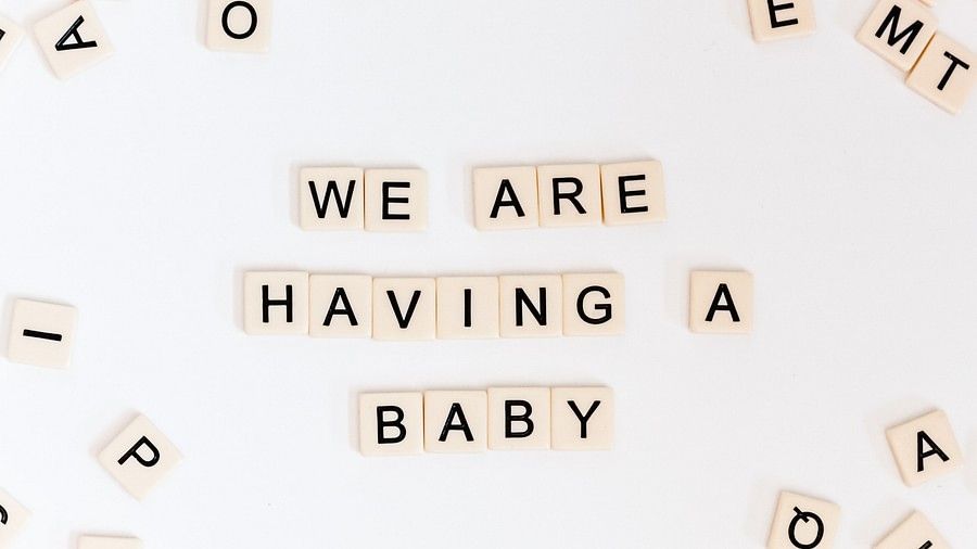 crossword tiles laid out saying we are having a baby at Azaya Beach Resort - the best resort for baby shower in goa