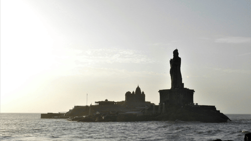 A tall statue surrounded by a water body