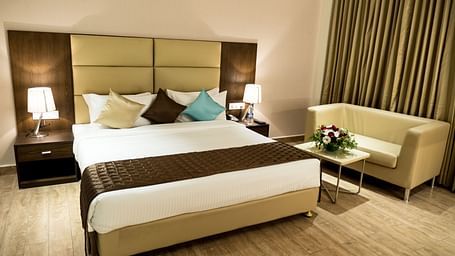 A large bed in Premium Room at Grand Ashok, Thanjavur.