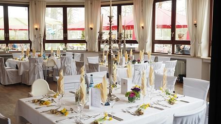 tables and chairs placed in clusters in a hall