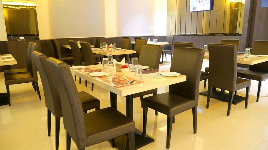 dining of a restaurant with warm lights of ASR Parklane, Hosur