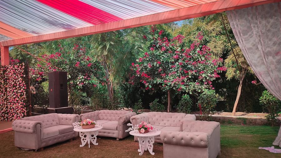 Outdoor event setup with plush sofas, small tables, and a colourful draped ceiling. - Bamboo Saa, Udaipur 
