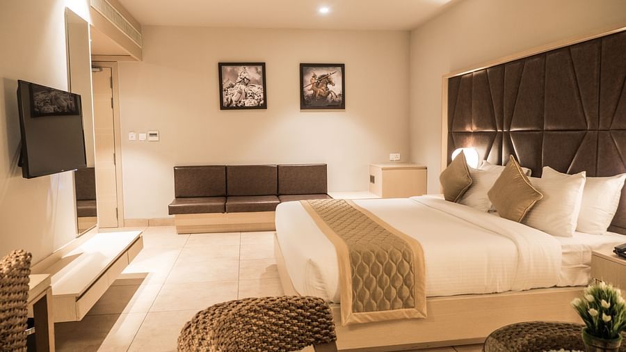 view of king size bed and TV of Premium Room at Cholaa Dynasty, Kumbakonam