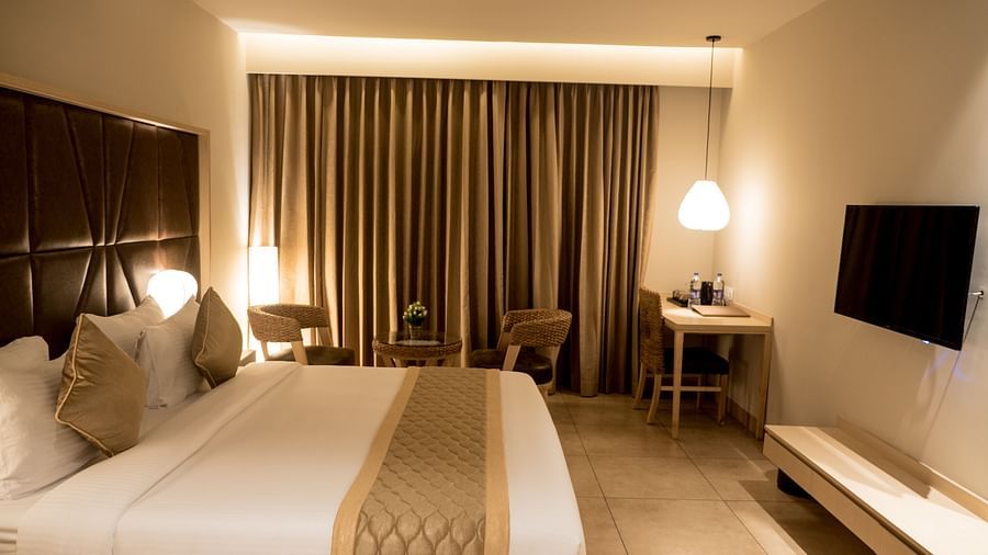 view of king size bed and TV of Premium Room at Cholaa Dynasty, Kumbakonam