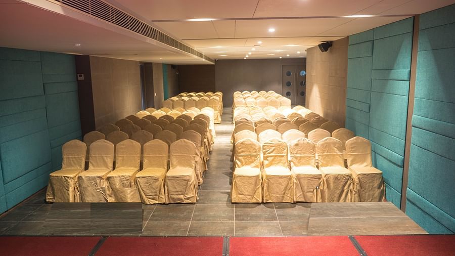 event halls white chairs at Cholaa Dynasty, Kumbakonam