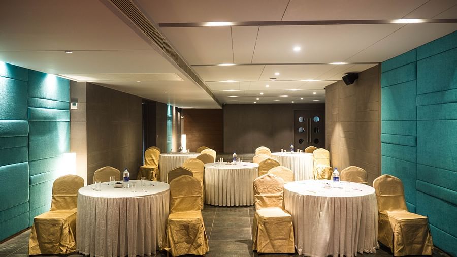 event halls with yellow chairs and white table at Cholaa Dynasty, Kumbakonam