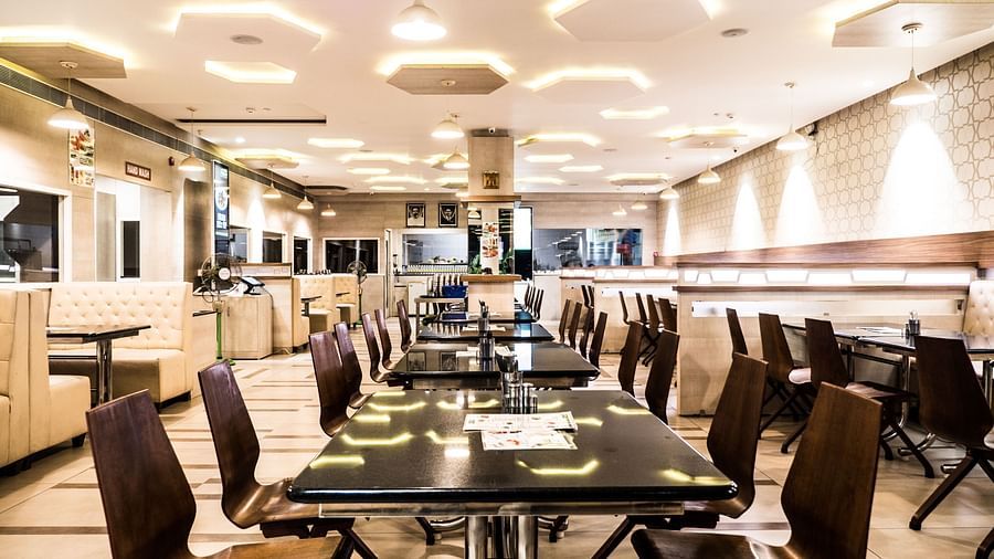 The board room with a huge table surrounded by chairs at Grand Ashok, Thanjavur.