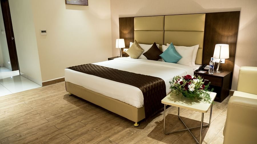 A large bed in Premium Room at Grand Ashok, Thanjavur.