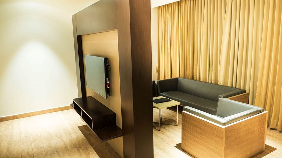 A partition with the living area placed in the right side of Suite at Grand Ashok, Thanjavur