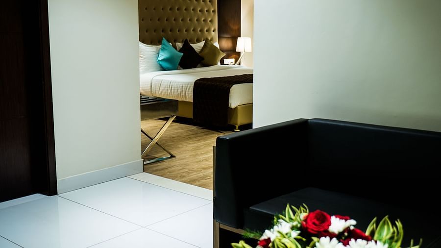 A view of the bed from the living area of Suite at Grand Ashok, Thanjavur