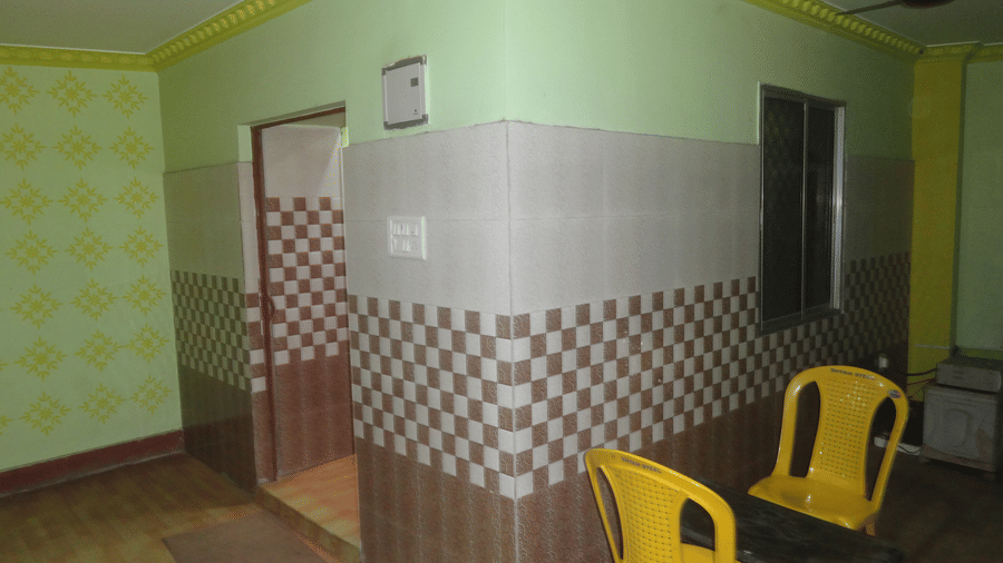 A Family Cottage at Khairi Resorts features 2 seating chairs, tiled lower walls, and a small mat on the floor.