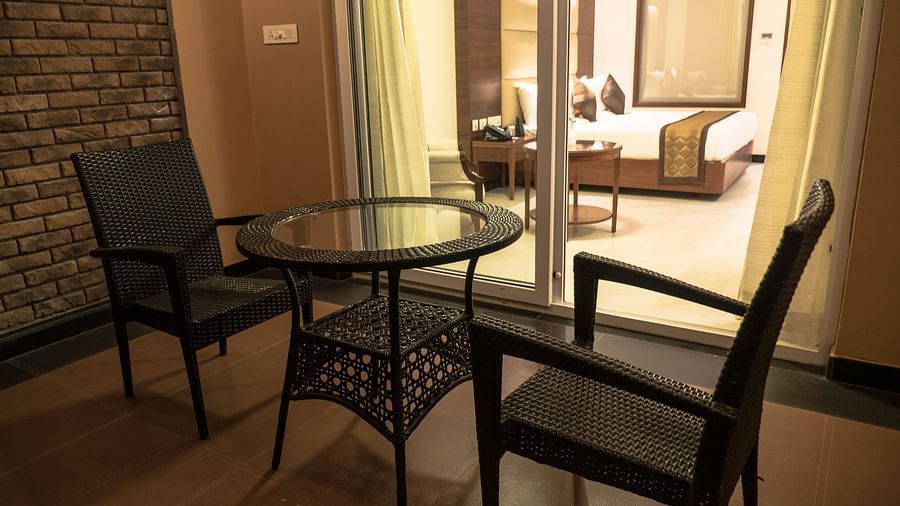 balcony with comfortable seating of a Premium Suite Room of MM Legacy, Kanchipuram