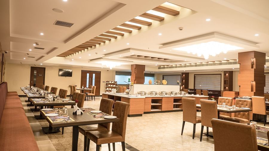 dining of a restaurant with warm lights of MM Legacy, Kanchipuram