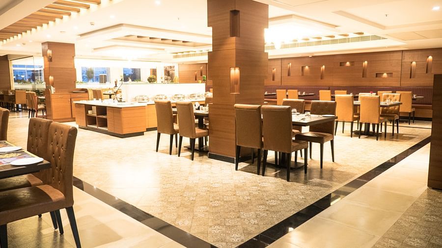 dining of a restaurant with warm lights of MM Legacy, Kanchipuram