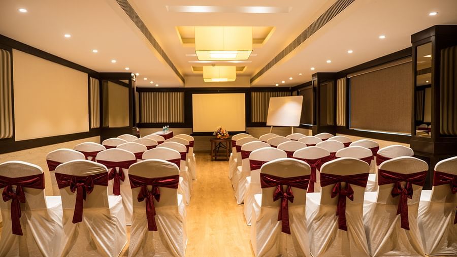 event hall with white satin chair and red ribbon of MM Legacy, Kanchipuram