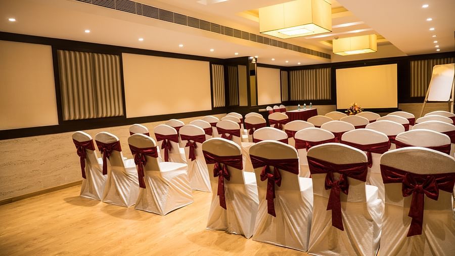 event hall with white satin chair and red ribbon of MM Legacy, Kanchipuram