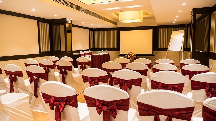 event hall with white satin chair and red ribbon of MM Legacy, Kanchipuram