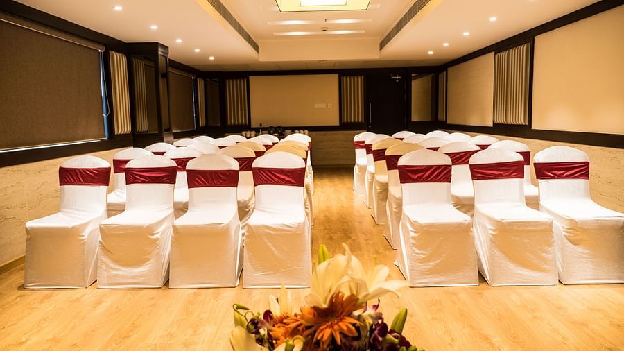 event hall with white satin chair and red ribbon of MM Legacy, Kanchipuram
