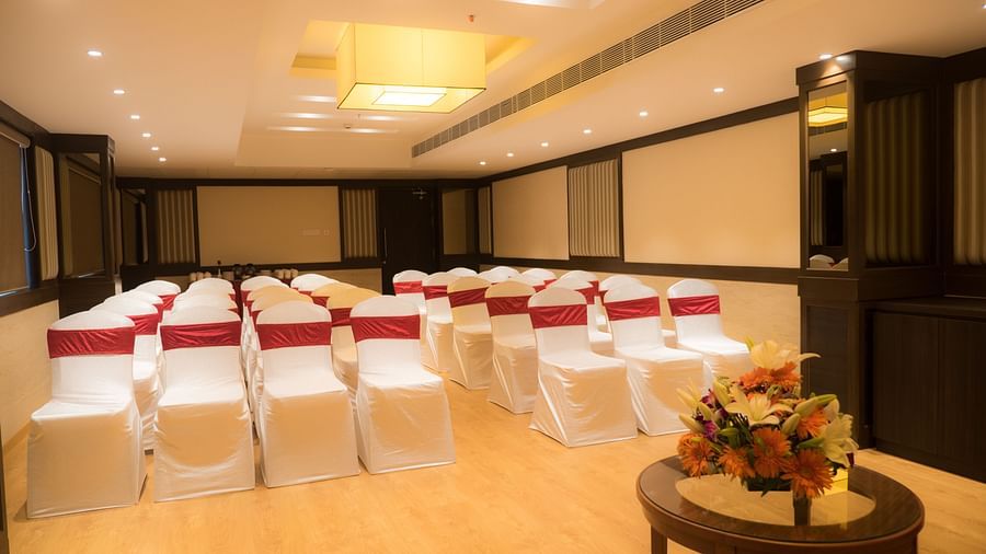 event hall with white satin chair and red ribbon of MM Legacy, Kanchipuram