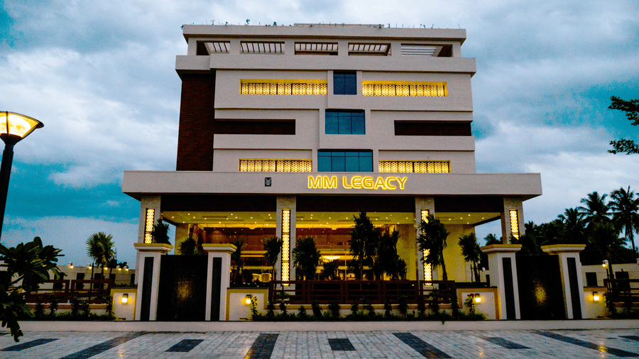 facade of MM Legacy, Kanchipuram, with sky in the backdrop.