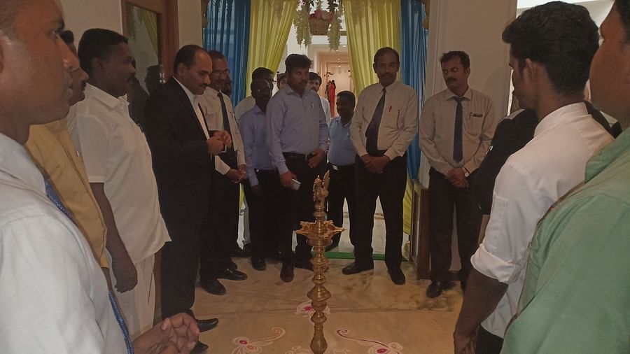  A group of people standing around a  lamp at SRM Hotel Tiruchirappalli- Hotel 