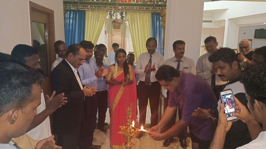 Man lighting a celebratory lamp at SRM Hotel Tiruchirappalli- Hotel 