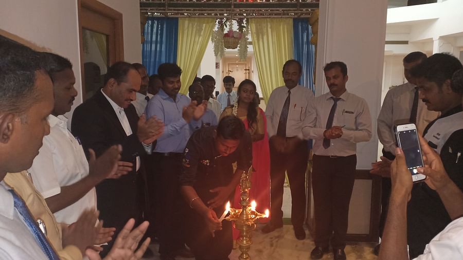 A man lighting a celebratory lamp at SRM Hotel Tiruchirappalli- Hotel 
