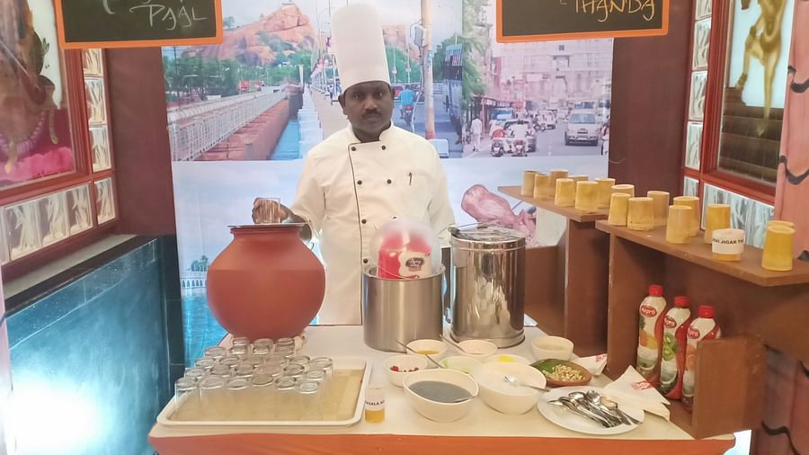 Man standing behind a table of food at SRM Hotel Tiruchirappalli- Hotel 