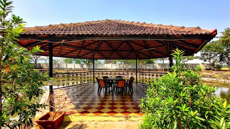 A close-up of a gazebo surrounded by lush, green plant with small leaves | The Kanila Resort
