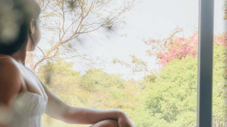 A woman sitting in an outdoor space at Karma Chalets.