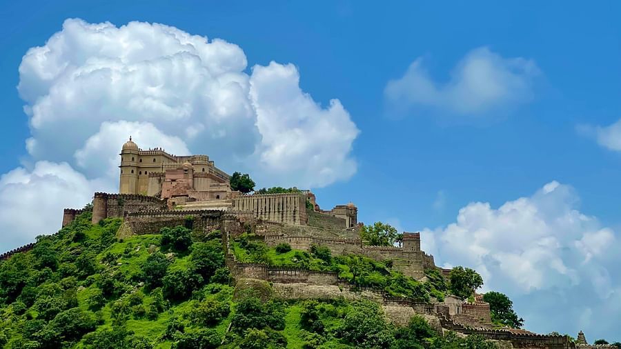 A wide view of a fort surrounded by greenery on a cloudy day