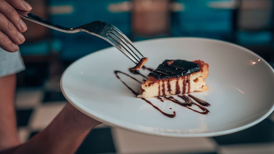 A person digging into a cheesecake