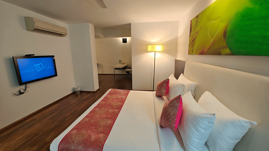 Suite with a plush king size bed facing the TV in fron of it and a floor lamp next to it at Springs Hotel & Spa