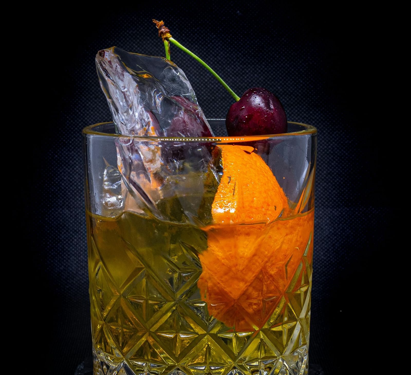 A cocktail served in a glass placed on the counter.