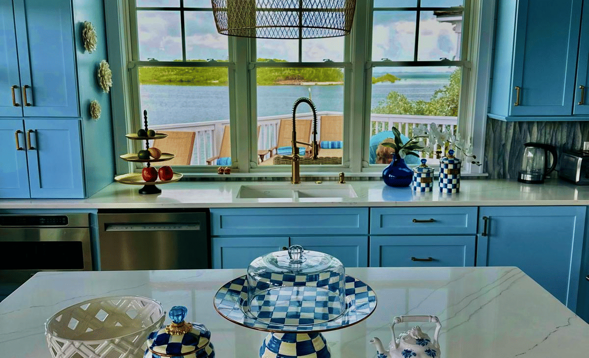 The dining area of Elbow Room Villa 7 in  Abaco inn with a large window and wooden cabinets