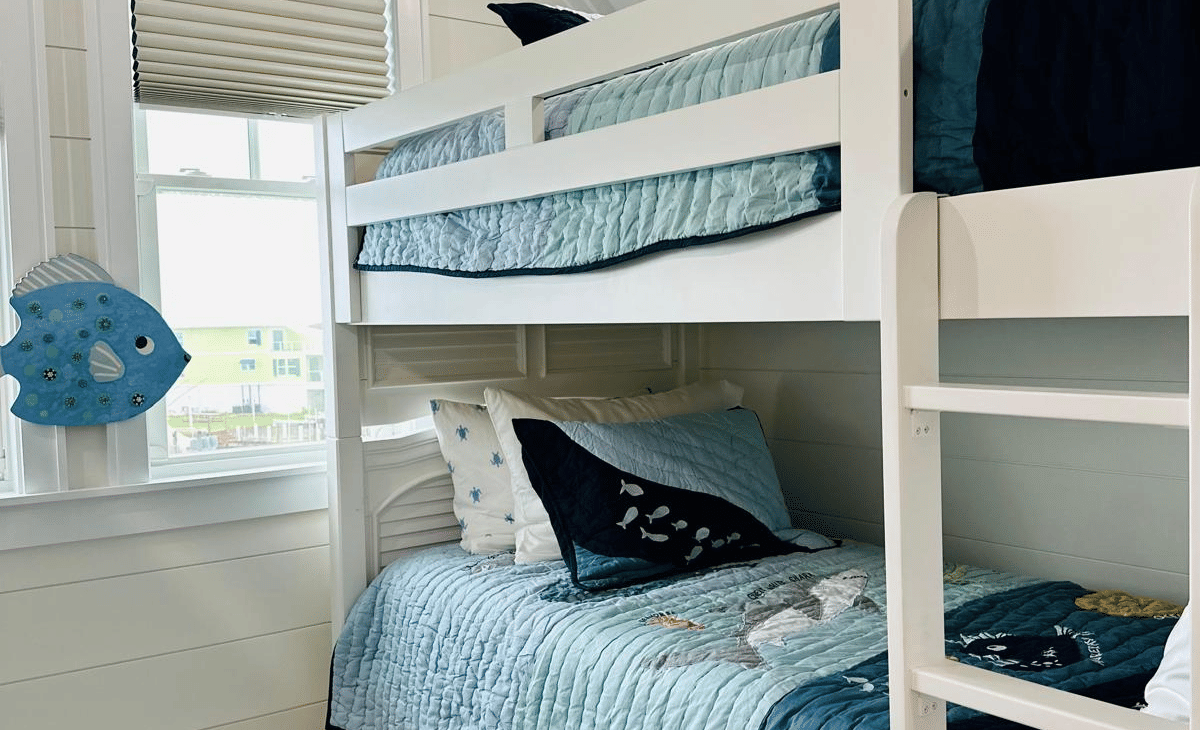 A side view of a bedroom at Elbow Room Villa 7 in  Abaco inn with a bunk bed and a small window