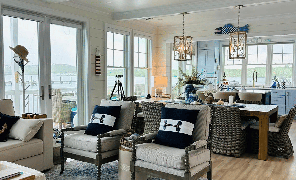 The living area of Elbow Room Villa 7 in  Abaco inn with patterned rug, multiple armchairs, ceiling fan, and modern furnishing