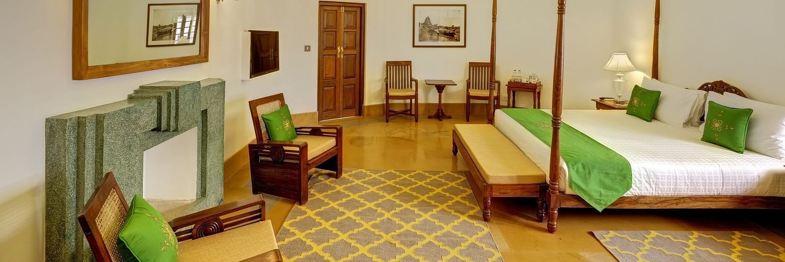 Heritage Suite with a double bed and a seating area at Saraca Hotel, Lucknow