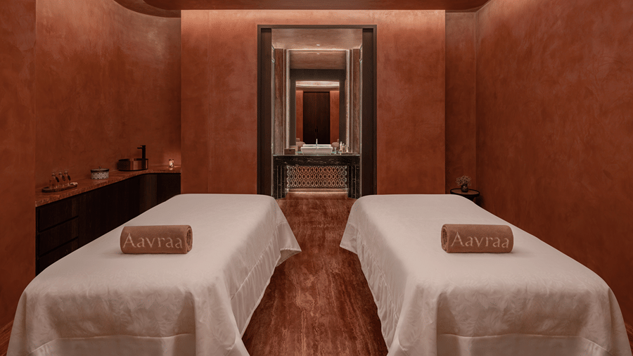 Spa treatment room with two massage beds set against warm toned walls at The Residency Signature Madurai.