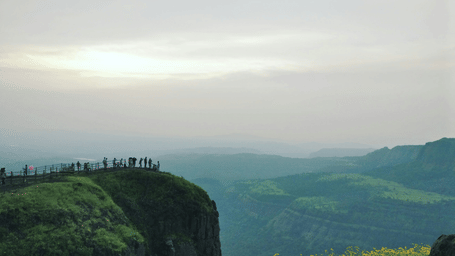 A scenic cliff view overlooking lush green valleys in Lonavala, perfect for a peaceful weekend getaway near Pune.
