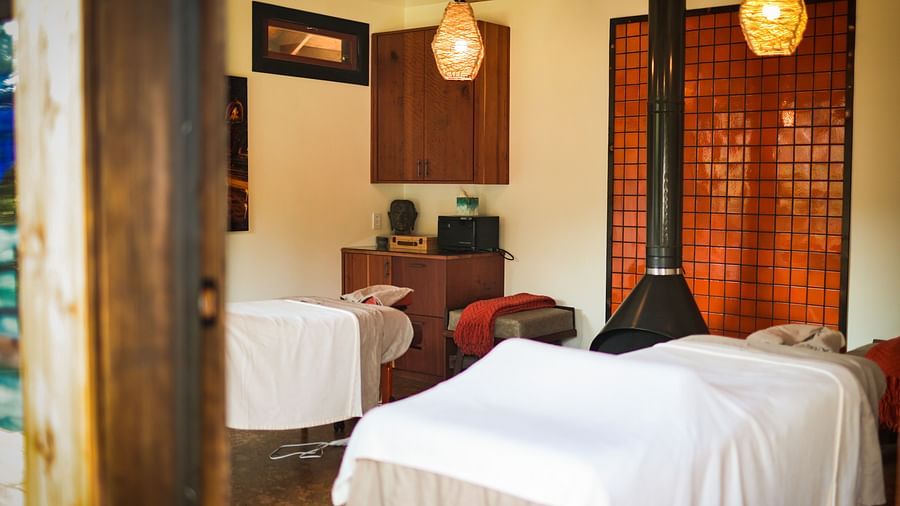 A tranquil massage room with twin beds and soft lighting at The Pavilion, Brewery Gulch Inn & Spa