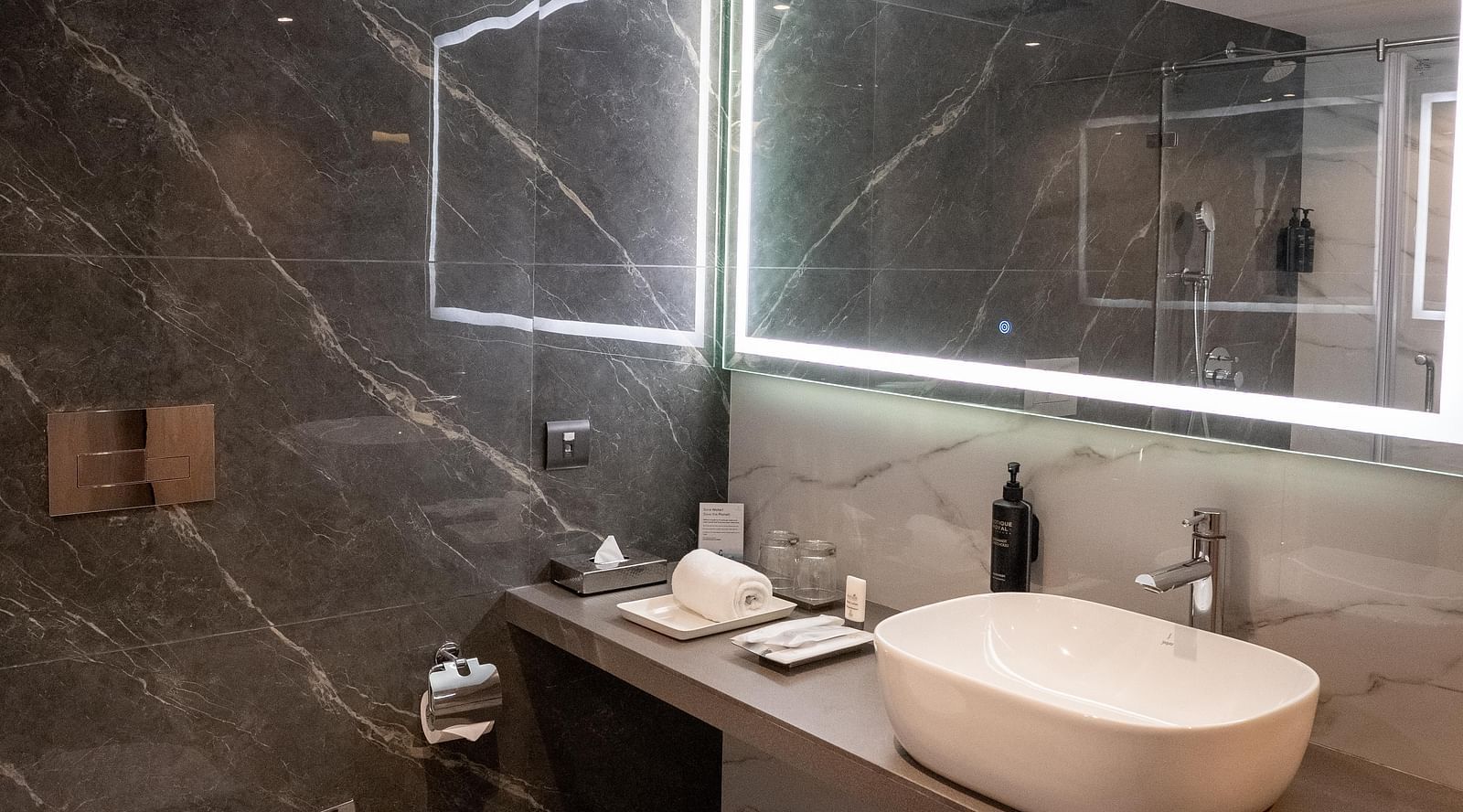 Stylish bathroom with sleek designs and a sink, mirror at ASTER GRAND BY ZENQ SAKET.