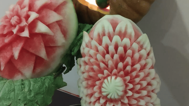 Another fruit carving display showcasing artistic floral designs on vegetables at Central Courtyard Boutique Hotel.