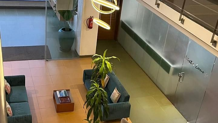 Spacious hotel lobby featuring comfortable seating and a multi-tiered chandelier - Astra Hotels and Suites Spice Garden