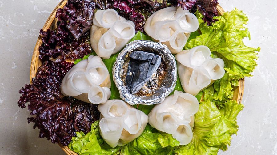 A top-down view of light food items surrounded by dark leafy vegetables on a plate.