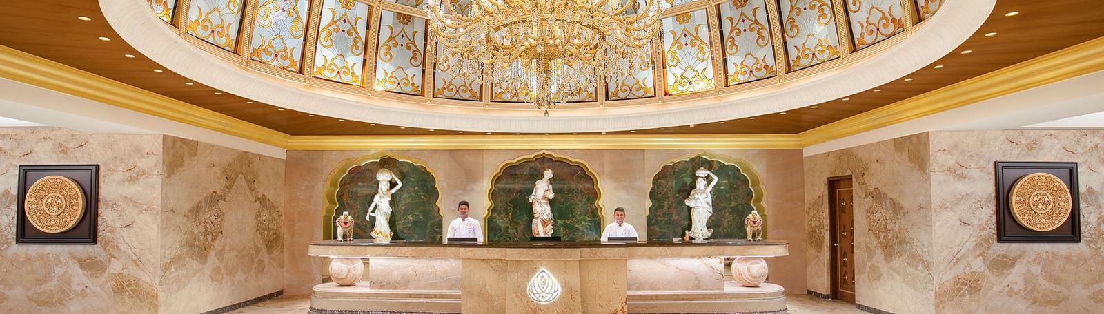 A reception area with a reception desk, receptionists and a giant chandelier - Kaldan Samudhra Palace