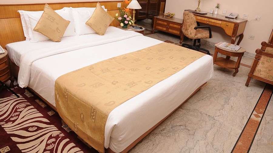 A comfy bed inside one of the rooms at Raj Park, a family Hotel in Chennai