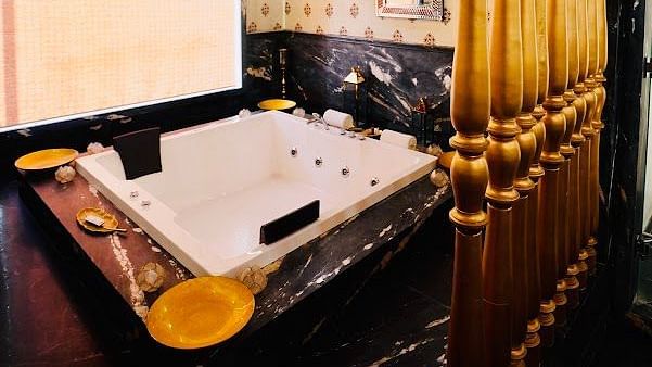 Image of a washroom with a jacuzzi and a chandelier above it at Rajasthali Resort & Spa Jaipur.