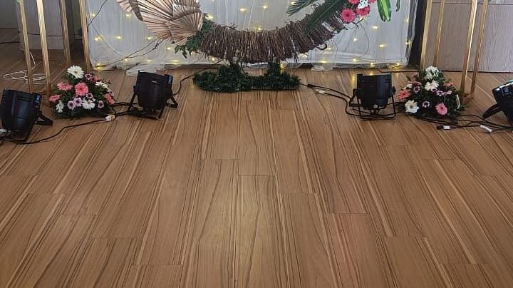 Image of a banquet hall with a large wreath as the backdrop at The Oriental Residency